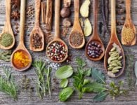 spices and herbs on wooden spoons