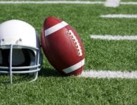 football helmet and ball on field