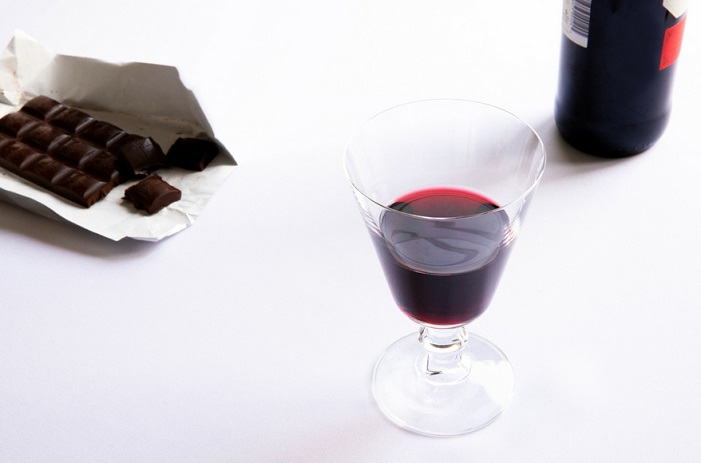 red wine and chocolate on white table