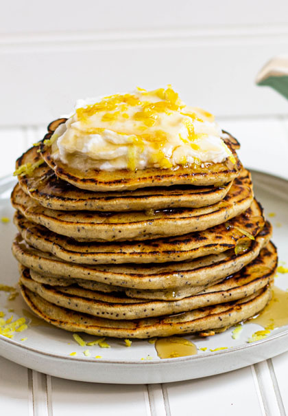 Lemon poppyseed pancakes stacked on plate