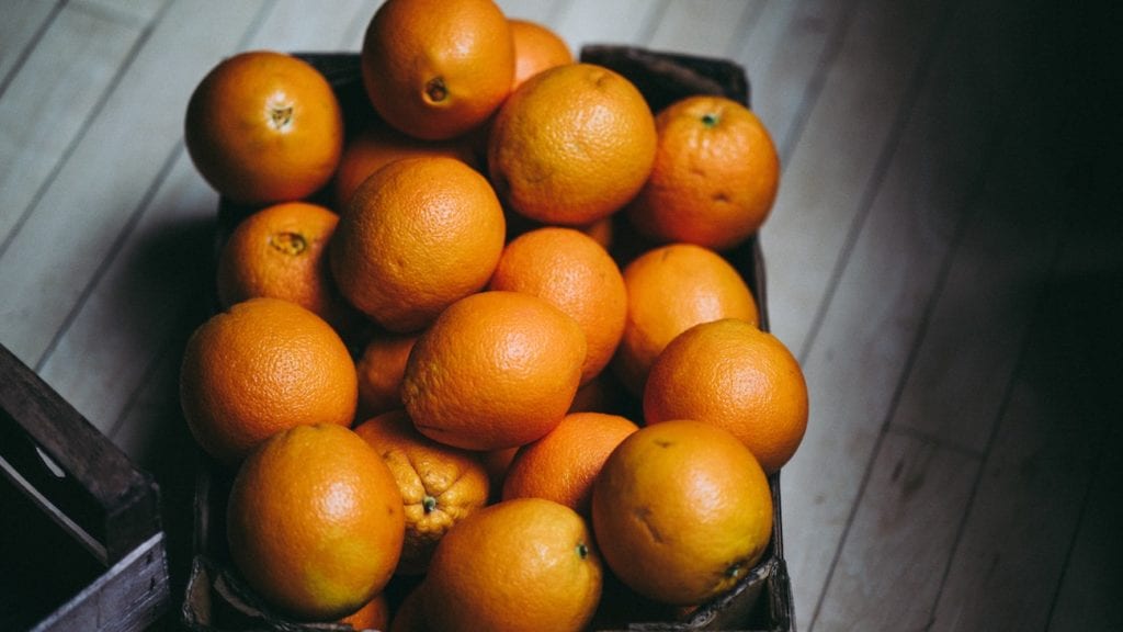 pile of oranges in a dark room
