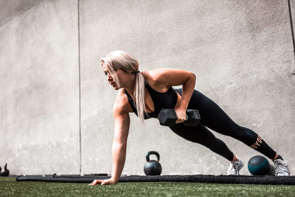 woman doing plank with weights
