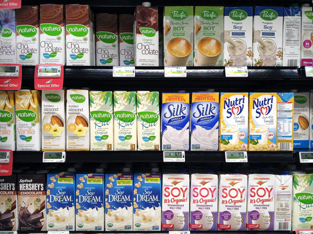 shelves of soy milk at the grocery store