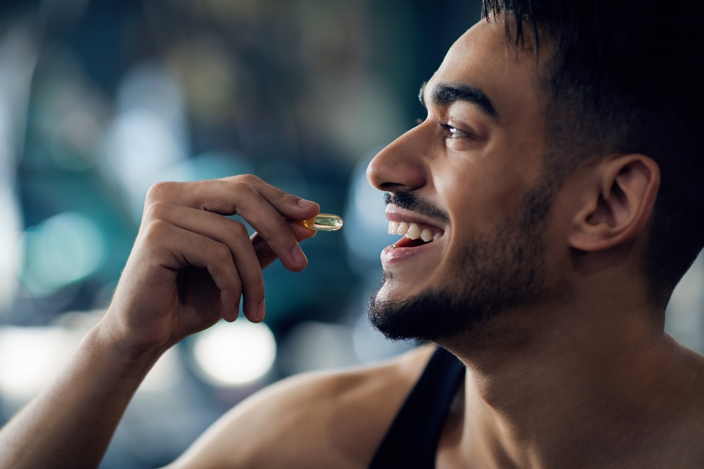 Man taking a supplemental vitamin to support his keto diet