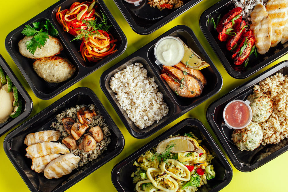 Various meal prep containers with Keto-friendly foods. 