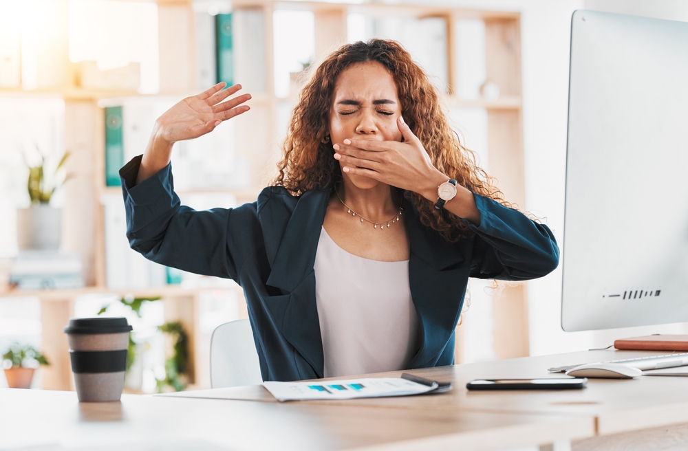 woman yawning at desk